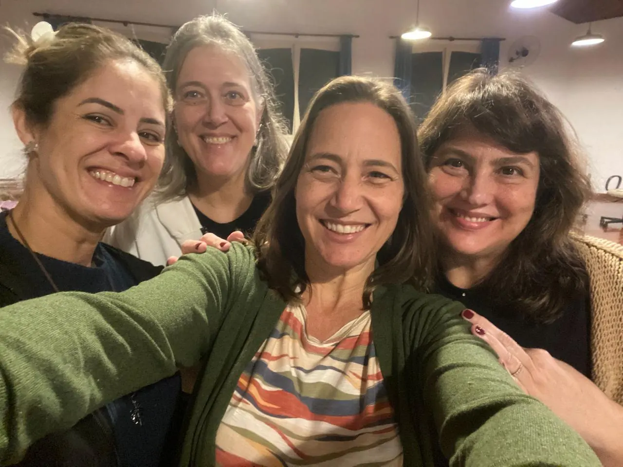 Quatro integrantes sorrindo juntas